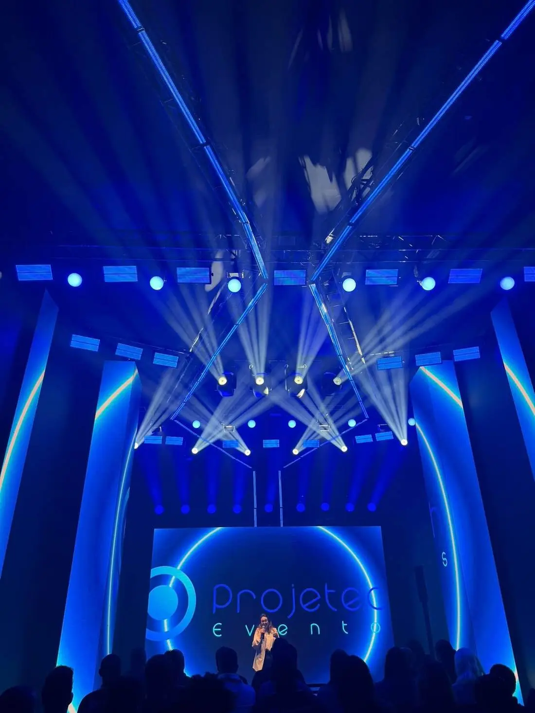 Corporate event stage with LED walls and stage lighting